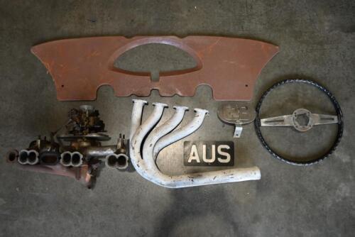PARTS: One competition exhaust headers.One black and silver steering wheel. One GB touring plate. One AUS touring plate. One six cylinder exhaust manifold fitted with Solex carburettor. One 1930's style metal dash panel.