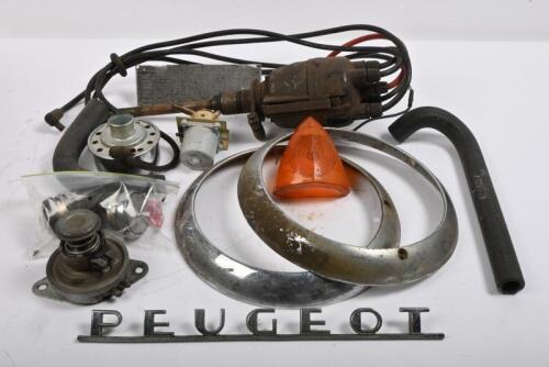 PEUGEOT: One box of Peugeot parts including, distributor, pair of side lamps, two hoses, lubricant plate, pair of headlight rims, Peugeot boot badge, Dashboard clock with chrome ring - positive earth.