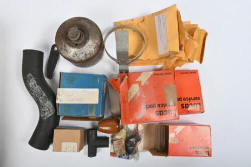 TRIUMPH: TR 4/5/6 Series. One box of NOS and used parts including. TR6 Tail light lenses. 6 packets of assorted screws. One fluid bottle holder. Three hoses. One oil filter top. One instrument rheostat knob. One gear knob
