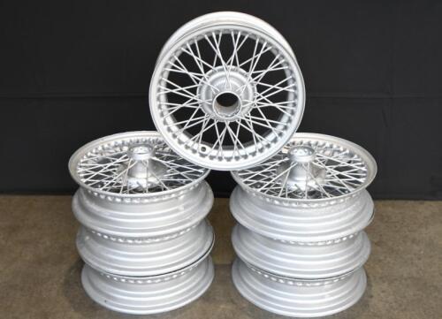 WIRE WHEELS: A group of seven 15 inch 48 spoke wire wheels, recently repainted in silver. Suit TR3 or others