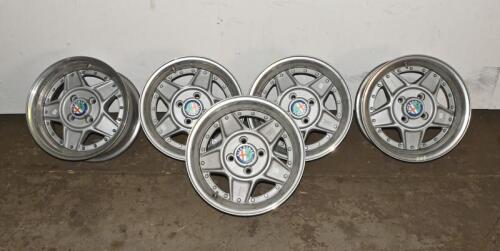 ALFA ROMEO: A set of five Simmons B-45 15 x 7.5 alloy racing wheels with Alfa Romeo livery grease cap, removed from a Montreal. Can be used on a wide range of cars