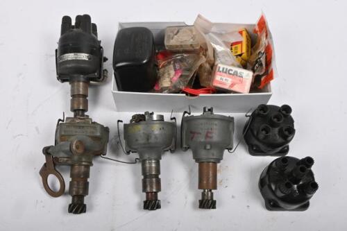 MG: One clear box containing four distributors, two distributor caps, generator brush set and Lucas regulator cap.