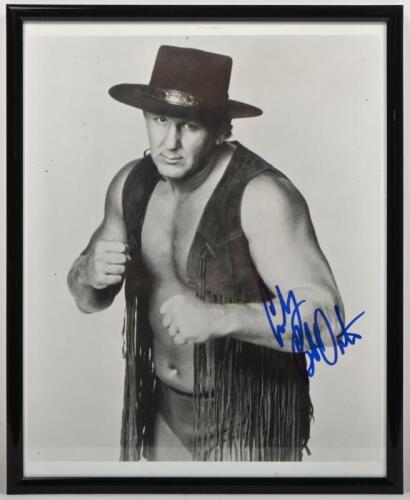 BOB ORTON: A framed and glazed black and white picture of 'Cowboy' Bob Orton autographed by Orton