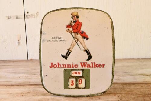 JOHNNIE WALKER: A vintage Johnnie Walker whisky tin advertising shop display calendar with embossed lettering and logo