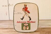 JOHNNIE WALKER: A vintage Johnnie Walker whisky tin advertising shop display calendar with embossed lettering and logo