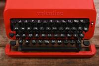 OLIVETTI: A circa 1970s Valentine red ABS plastic and powder coated metal portable typewriter in carrying case designed by Ettore Sottsass and Perry King for Olivetti, the case 11.5cm high, 34cm wide, 35cm deep - 2