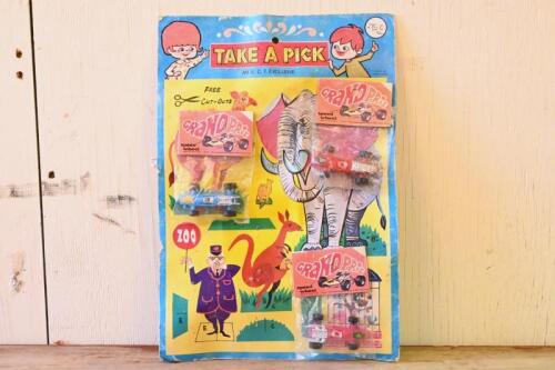 TAKE A PICK: Rare vintage unused "TAKE A PICK" with three unopened bags of Grand Prix racing cars by Speed Wheel, made in Hong Kong, cardboard has cut out animals as additional toy, good condition, great for display
