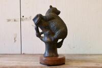 BRONZE: A cast bronze figure of a small brush tail mammal on bamboo, on a marble base, 25cm high