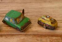 JAPANESE TIN CARS: A collection of four circa 1960s Japanese lithograph printed tin models, including a clockwork tank and Mini Cooper MK II, longest 8.5cm long - 3