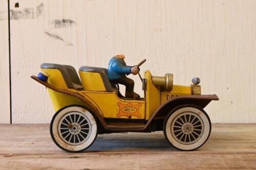 MR MAGOO: A 1961 Japanese battery operated lithograph printed tin Mr Magoo toy, lacking the head of the driver, 23cm long