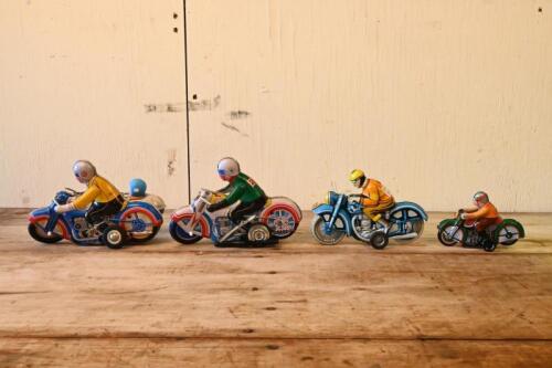 TIN TOYS: A collection of four lithograph printed tin motorcycle toys, including two clockwork operated toys, largest 18cm long
