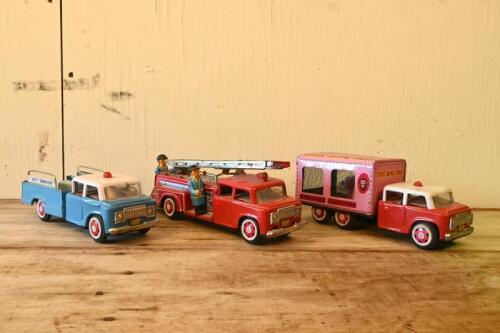 TIN TOYS: A collection of three vintage friction operated lithograph printed tin truck toys, largest 27cm long