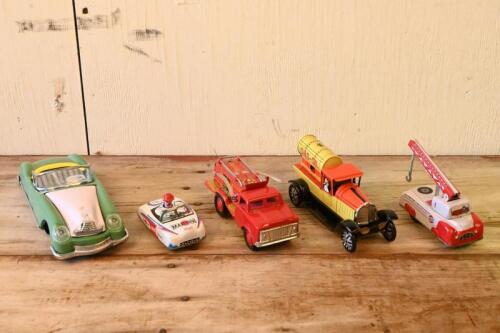 TIN TOYS: A collection of five friction driven lithograph printed tin toys, largest 21cm long