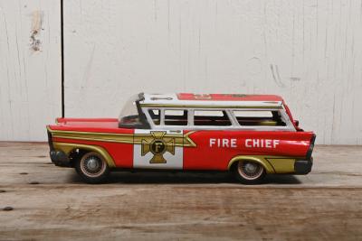 TIN MODEL: A circa 1950s Japanese friction driven lithograph printed tin model of a Ford Fire Chief car, 25cm long