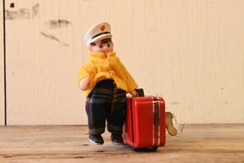 CAPTAIN: A novelty vintage clockwork tin and plastic toy of a Captain and his suitcase, 15cm high