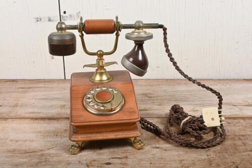 TELEPHONE: A reproduction rotary telephone in oak and brass case