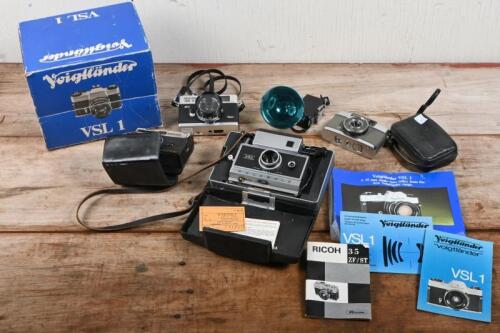 VINTAGE CAMERAS: A large lot of vintage cameras and equipment including Canon 'Canonet', Voigtlander VSL1, Polaroid 250 'Land Camera' with external flash and three others