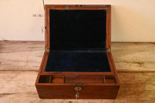 WRITING SLOPE: A vintage wooden writing slope box, brass corner details, felt interior, and multiple compartments for writing utensils and paper. Complete with key