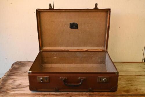 SUITCASE: A vintage brown suitcase with wooden edging, with no key.