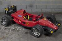 CHILDS CAR: An impressive Italian "Toys Toys" children's battery powered toy car of Alain Prost's 1990 Ferrari F1-90, steel chassis framework with moulded plastic body panels, electric motor, approx 210cm long
