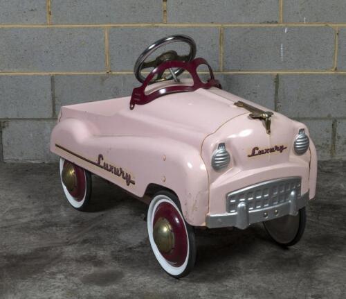TOY CAR: A reproduction pink painted children pedal car, 90cm long approx