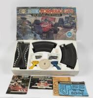 SCALEXTRIC: A circa 1970s Scalextric Formula 1 GP 8 set in box with track plans and extras, lacking motor and general completeness unknown