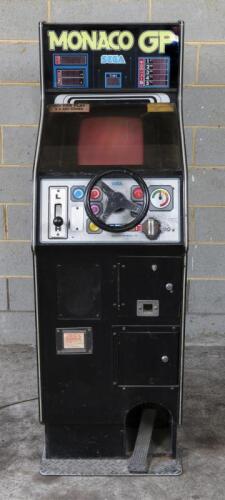 SEGA: A circa 1980 Japanese Sega "Monaco GP" upright single player arcade video game, 145cm high, sound appears to be working, screen is on but is temperamental, pedal appears to work, steering wheel rotates but has no effect, electrical points have oxidi