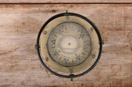 NAUTICAL COMPASS: An early, metal and brass magnetic ships compass by Proud's Ltd limited Sydney, set in fluid with face reading 'Trade Sestrel Mark', with balancing bracket