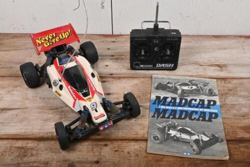 TAMIYA: A 1/10 scale Tamiya 'MADCAP' remote control car with controller and owners manual