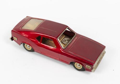 COUPE: A circa 1970s friction driven tin model of a two door coupe with lithograph printed interior, 23cm long