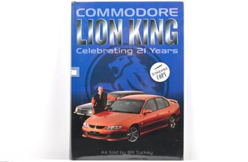 HOLDEN: A hardcover book - 'COMMODORE LION KING - Celebrating 21 Years - as told by Bill Tuckey. Book with multiple signatures including Peter Brock, Jason Bargwana, Russell Ingall, Cameron McConville & Greg Murphy