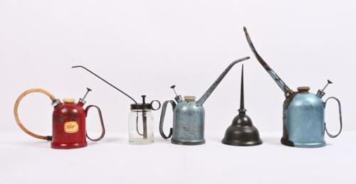 OILERS: A group of five 1950s/1960s tin and glass oilers, blue and red examples by Rega, tallest 27cm high