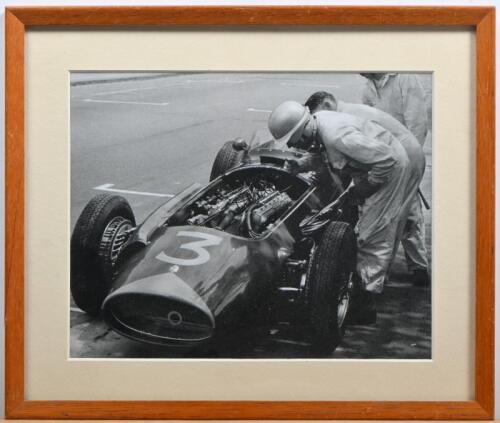 MASERATI: A black and white picture of Maserati 250F with driver and pit crew