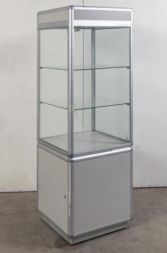 DISPLAY CABINET: A tall glass square display cabinet, fitted with two glass shelves, storage cabinet compartment and lights