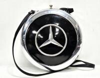 A decorative lined ladies handbag constructed from two Mercedes-Benz hubcaps, 25cm diameter, by automotive artist Terry Lawrie