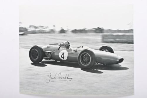 BRABHAM: A reproduced black and white picture of Sir Jack Brabham racing a Brabham Climax at 1963 Australian Grand Prix, Warwick Farm. Sir Jack Brabham signature