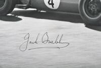 BRABHAM: A reproduced black and white picture of Sir Jack Brabham racing a Brabham Climax at 1963 Australian Grand Prix, Warwick Farm. Sir Jack Brabham signature - 2