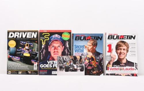 VETTEL: A collection of predominantly printed material featuring Sebastian Vettel. 2008 color photograph of the Toro Rosso F1 as raced by Sebastian Vettel. Photograph signed by Vettel