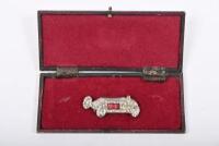 GP CAR: An Edwardian brooch of a Grand Prix racing car, inset with stones, in period box with later clasp. Overall length of 5cm