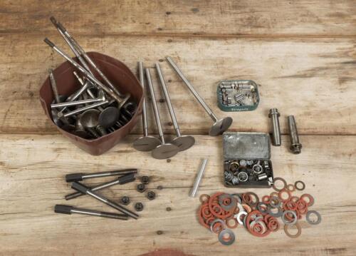 VALVES: A assortment of various un-machined and machined valves, valve springs and collets