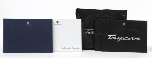TAYCAN: Two Porsche Taycan 'Porsche E Performance' catalogues in plastic pouch along with two copies of 'The Porsche Principle' one 2015 the other 2020.