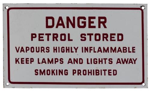 DANGER: A 'DANGER Petrol Stored' white enameled tin sign, (19cm high x 32.5cm wide)