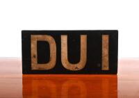 DUI: A wooden English 'DUI' number plate