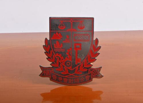 HONG KONG: A Hong Kong "HK SA' steel badge with red enamel motifs