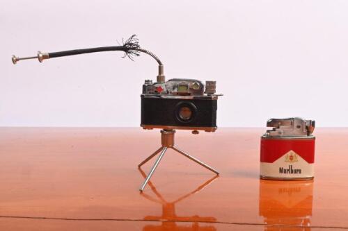 CIGARETTE LIGHTERS: Two cigarette lighters. Camera by KKW (Peace Gas) & Marlboro cigarette lighters