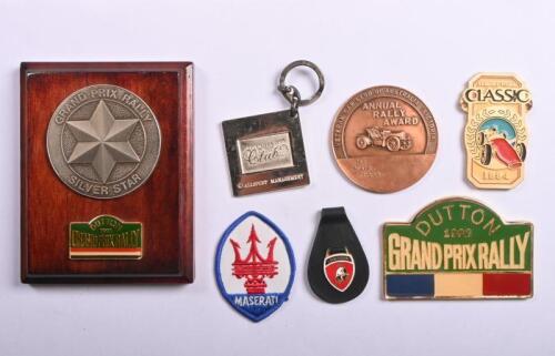 BADGES/PLAQUE: A collection of badges and one plaque. 1991 DUTTON GRAND PRIX RALLY SILVER STAR award