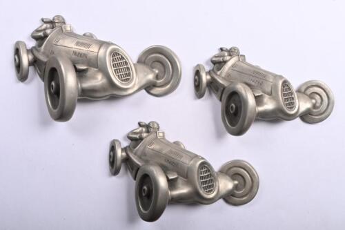 MOTOR RACING: Wall mounted pewter three piece set featuring vintage racing cars in a state of speed