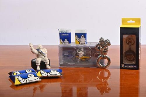 MICHELIN MAN: A group of Michelin Man related items. Limited Edition Motorcycle Wheel, ear plugs, bottle opener. Michelin Wheel key ring