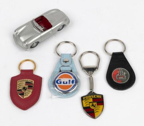 PORSCHE: A collection of Porsche related key rings and 1:43 scale Schuco Porsche 550 Spyder. '911 Gruppe' key ring