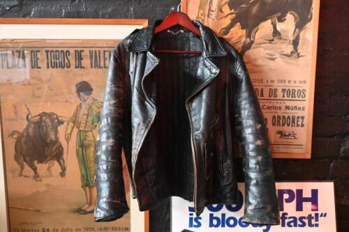 MOTORCYCLE JACKET: A period American black heavy leather motor cycle jacket. Rear of jacket with artwork 'ROCKY MOUNTAIN, HARLEY DAVIDSON, ENGLEWOOD, COLORADO'